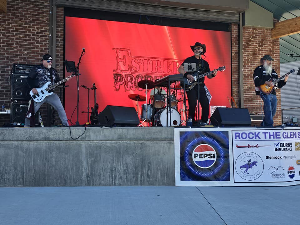 band performing in the town of glenrock in front of an led wall