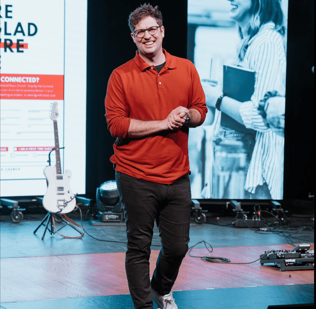 Pastor standing on a church stage with two new LED Walls.